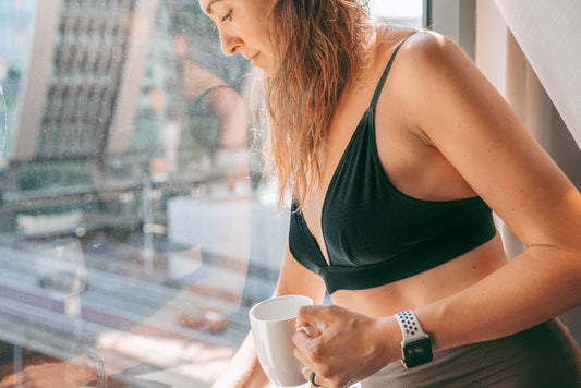 A woman wearing a WAMA triangle bralette to prevent boob sweat.