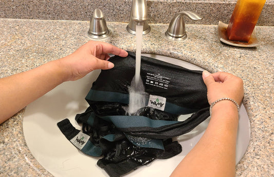 Woman showing how to hand wash underwear underwear in the sink.