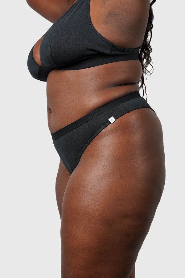 Side view of Hemp Thong underwear in black on model wearing size 2XL, 5'8" dress size 14