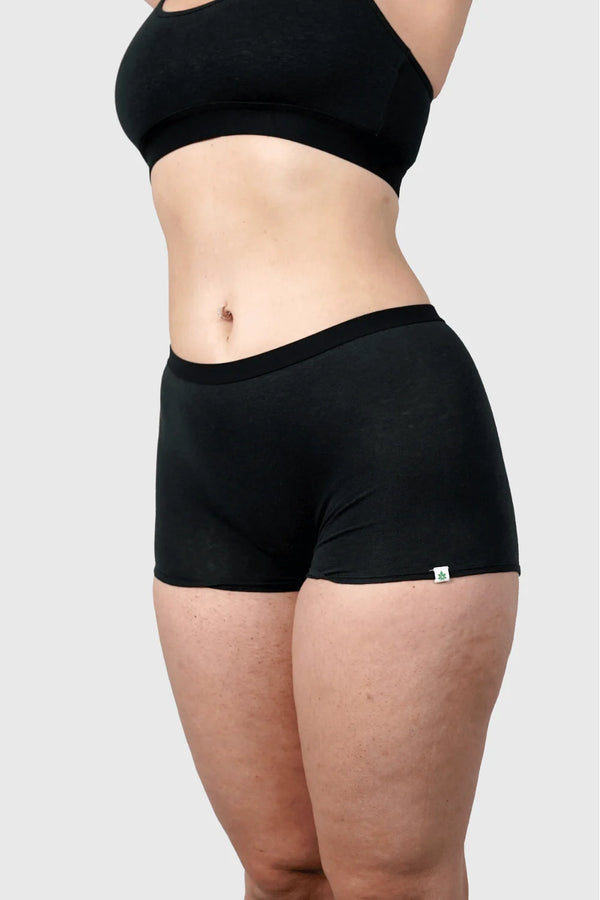 Side view of Hemp Boy Shorts in Black on model wearing size M, 5'10” dress size 6