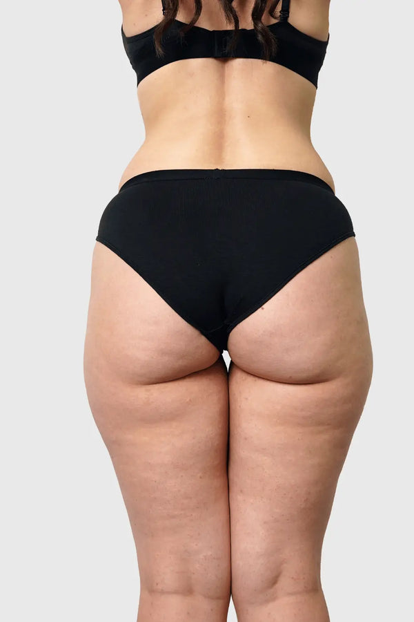 Back view of Hemp Bikini in Black on model wearing size M, 5'10” dress size 6