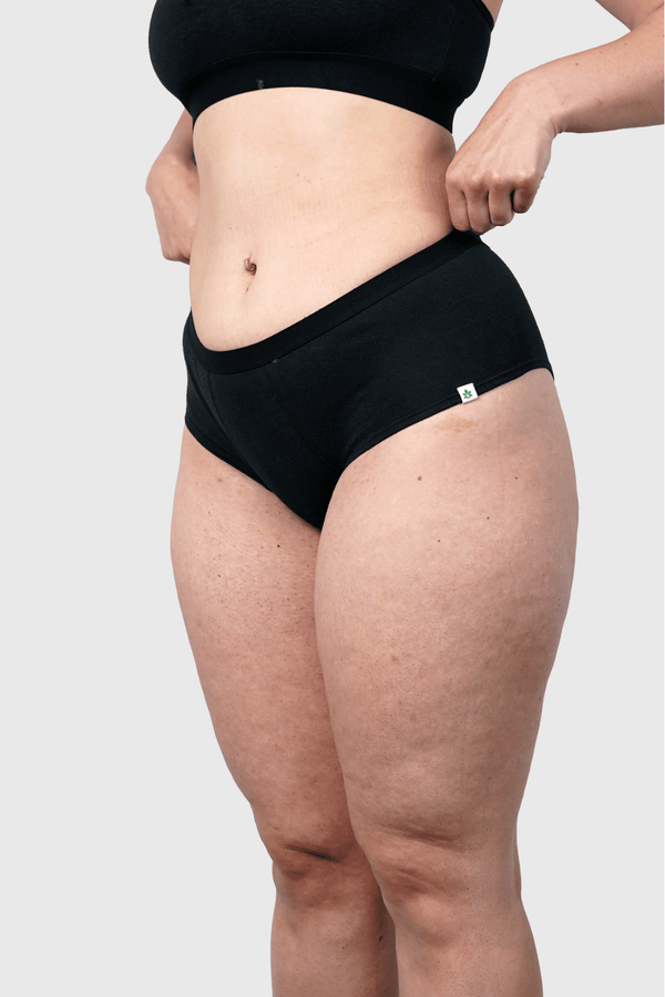 Side view of Hemp Hipster Panties in Black on model wearing size M, 5 ft 10 in dress size 6