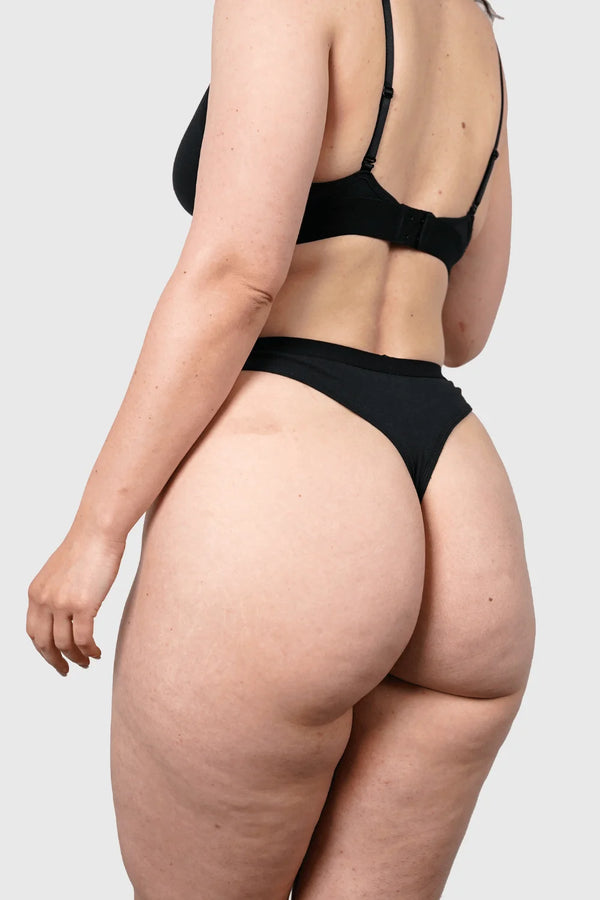 Back view of Hemp Thongs in Black on model wearing size M, Jess is 5'10" dress size 6
