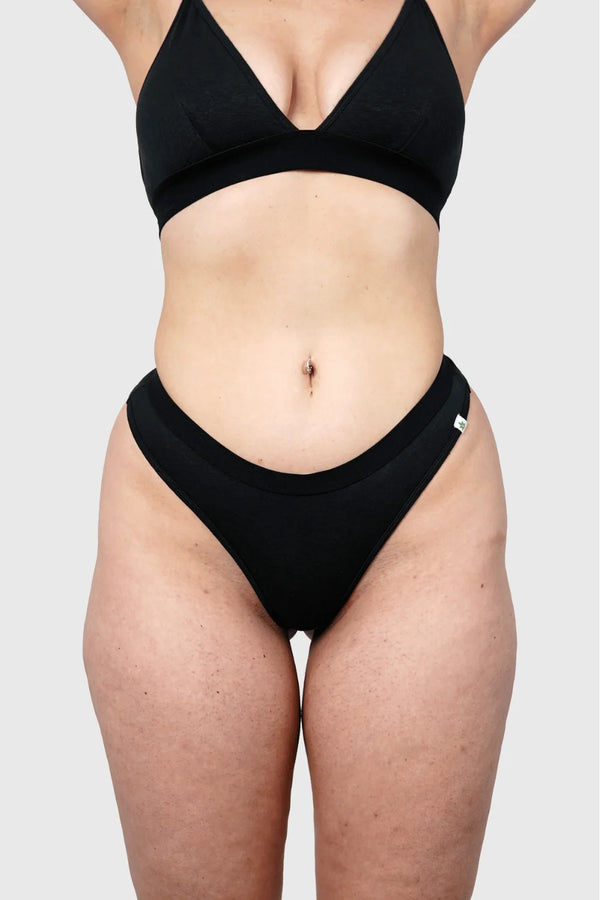 Front view of Hemp Thongs in Black on model wearing size M, Jess is 5'10" dress size 6