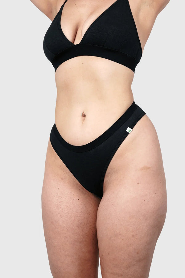 Side view of Hemp Thongs in Black on model wearing size M, Jess is 5'10" dress size 6