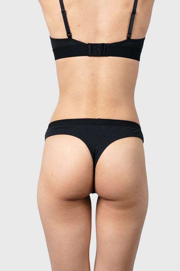 Back view of Hemp Thong underwear in black on model wearing size S, 5'10" dress size 2