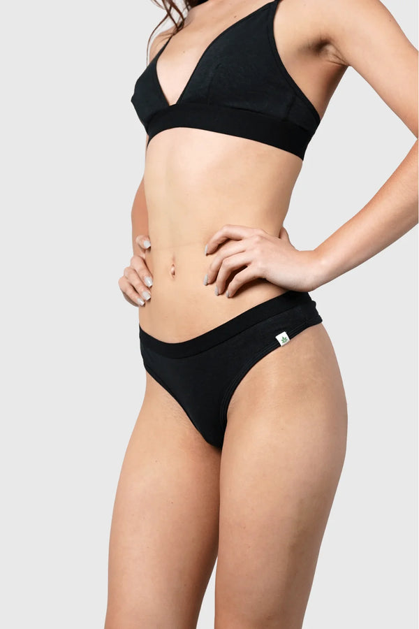 Side view of Hemp Thong underwear in black on model wearing size S, 5'10" dress size 2